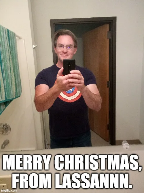 A man with glasses and a Captain America t-shirt takes a mirror selfie in a bathroom, holding a phone. The overlaid text…