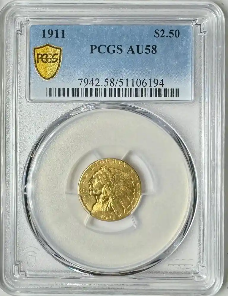 A 1911 $2.50 Indian Head gold coin is displayed inside a clear protective slab with a blue certification label from PCGS…