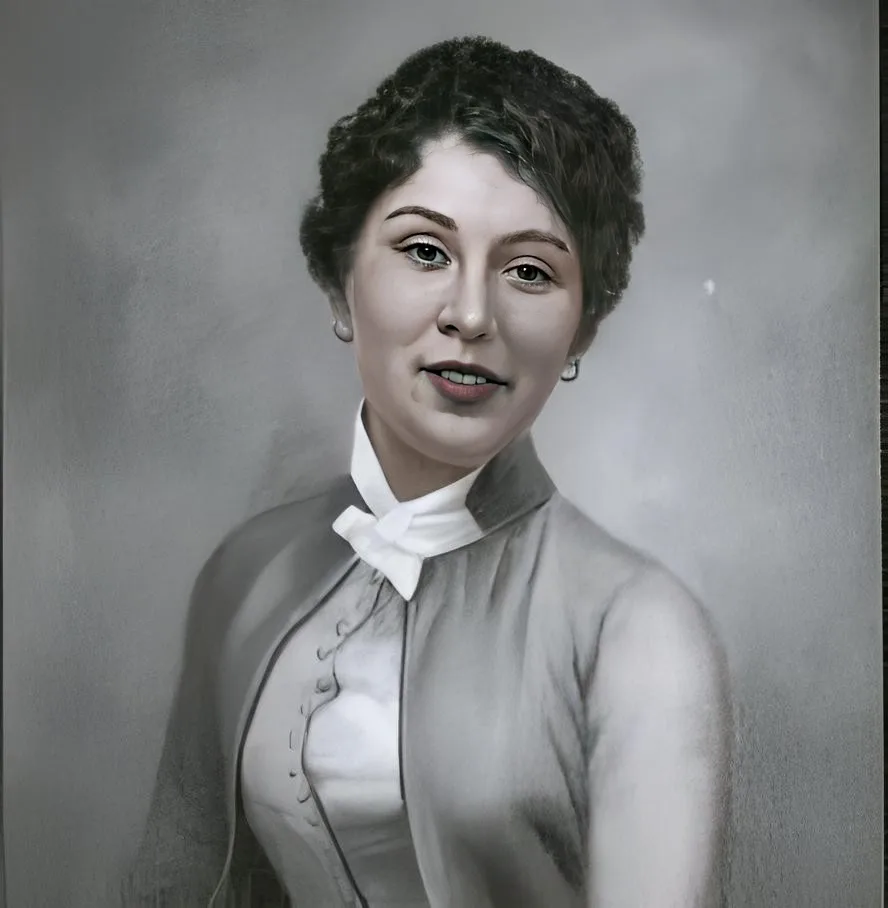 A vintage black-and-white portrait of a woman with short dark hair, wearing a collared blouse with a white bow tie and a…