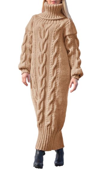 A person wearing an oversized, tan cable-knit turtleneck dress that extends to their mid-calves, paired with black boots…