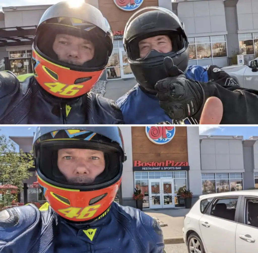 Two motorcyclists in helmets pose outside a Boston Pizza restaurant; one gives a thumbs-up while the other looks at the…