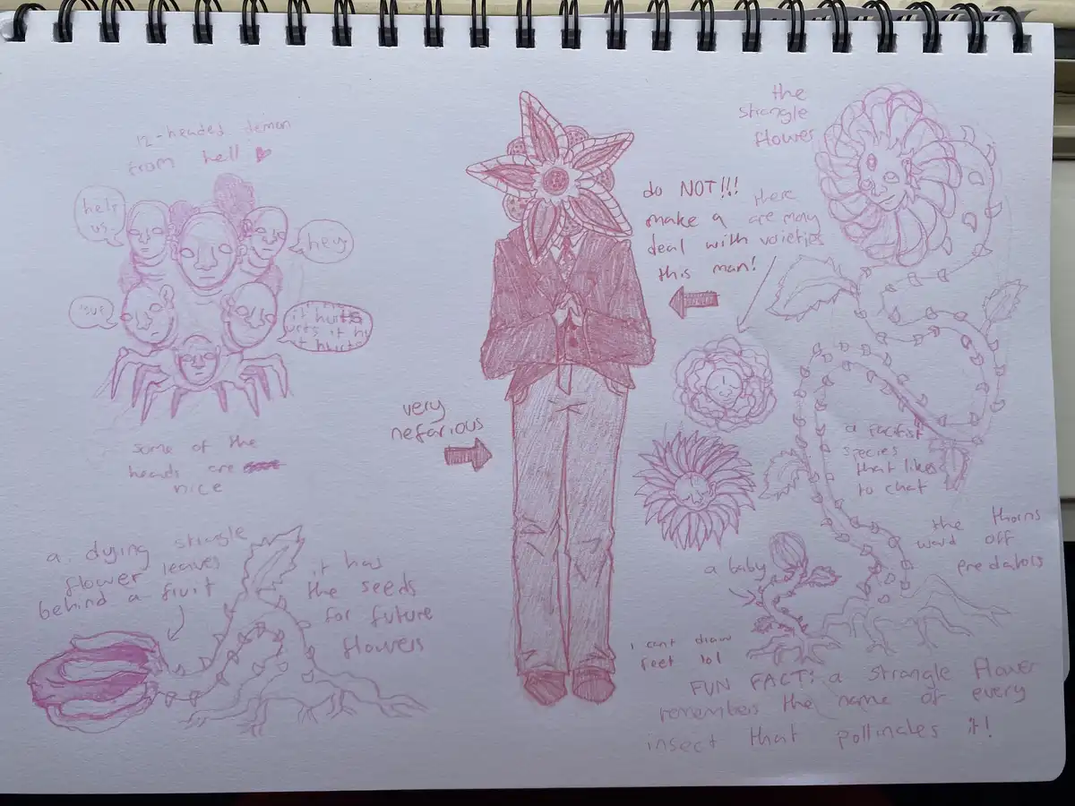 A hand-drawn sketch in a spiral notebook shows a person in a suit with a large, multi-petaled flower for a head, labeled…