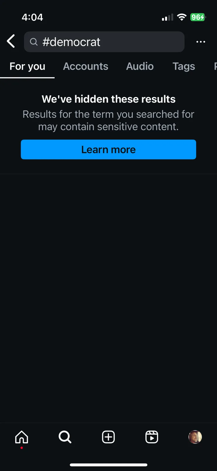 A screenshot of a social media app's search results page showing that the search for '#democrat' has been hidden due to…