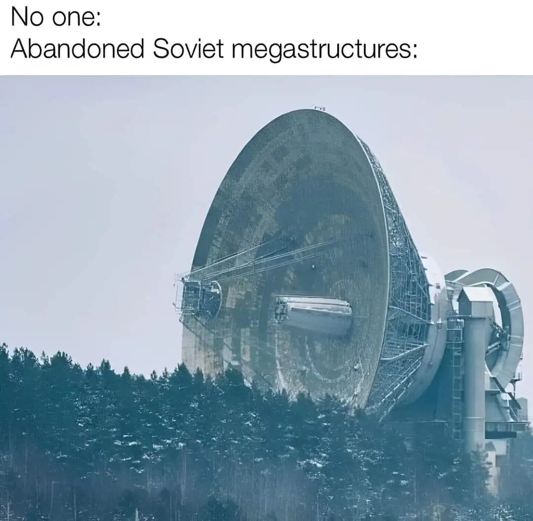 The image shows a massive, weathered, and partially collapsed satellite dish structure, likely the Yevpatoria Planetary…