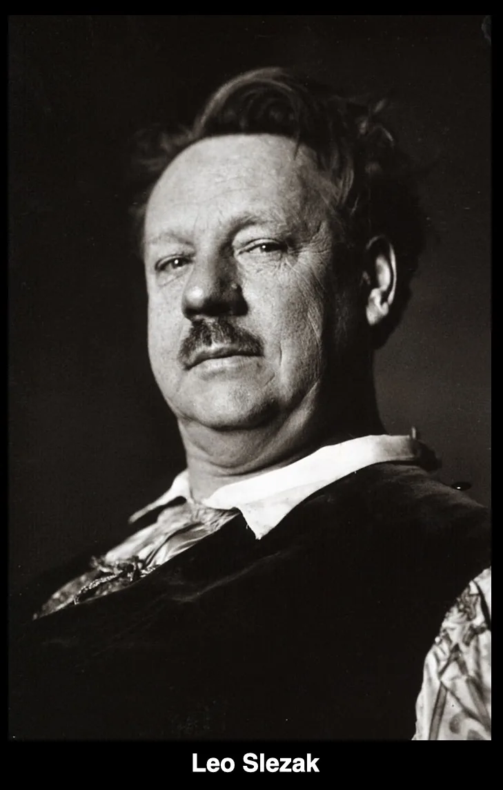 A black-and-white portrait of a middle-aged man with a mustache, wearing a dark vest over a patterned shirt and a white…