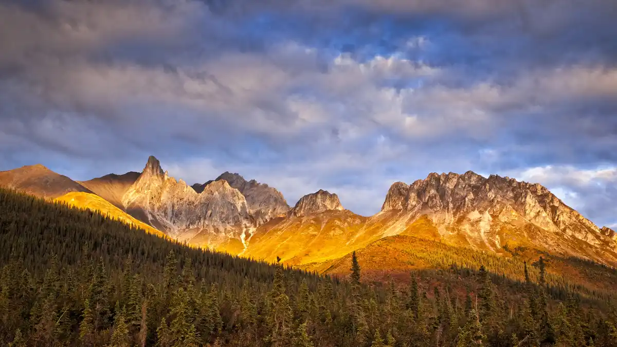 In the Arctic's vast wilderness, the 126-million-year-old Brooks Range forms a 700-mile-long continental divide. Here…