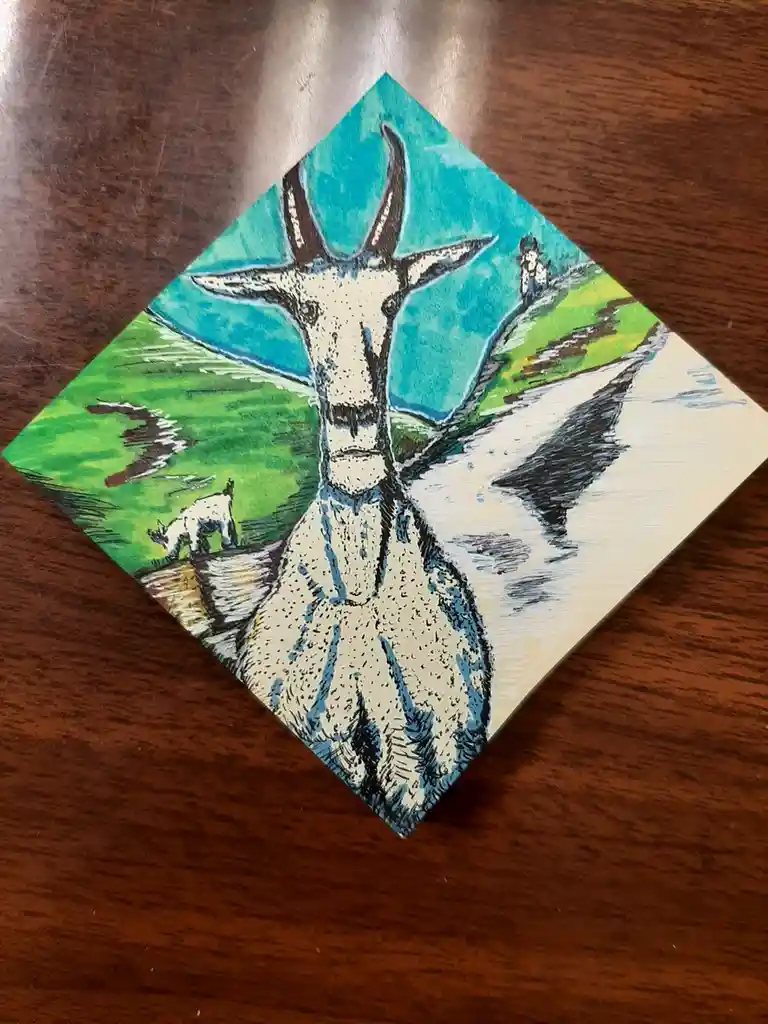 A hand-drawn illustration on a square canvas, rotated 45 degrees on a wooden surface, depicts a large white goat with horns…