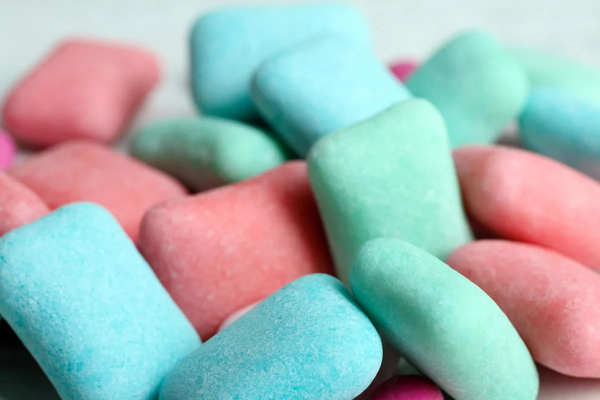 A close-up photo of assorted pink and blue sugar-coated candies, with the overlaid text reading 'i'm not a candy, i'm a…