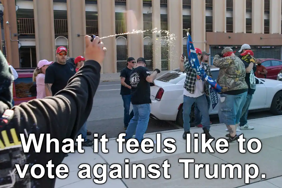 A group of people wearing red hats and holding flags stand around a white car, while a person in the foreground holds a…