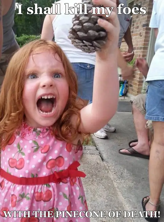 A young girl with red hair and a pink cherry-patterned dress is screaming with an intense, angry expression while holding up…