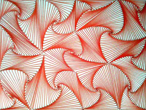 The image shows a close-up of intricate string art on a white surface, featuring repeating geometric patterns made of bright…