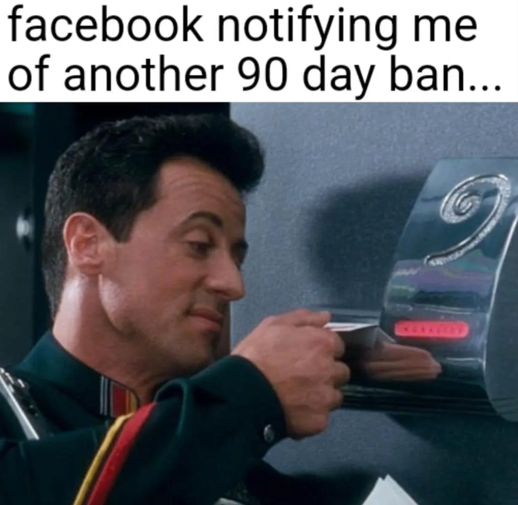 A man in a dark uniform with red and gold trim looks at a shiny, futuristic-looking device displaying the number '9' in a…