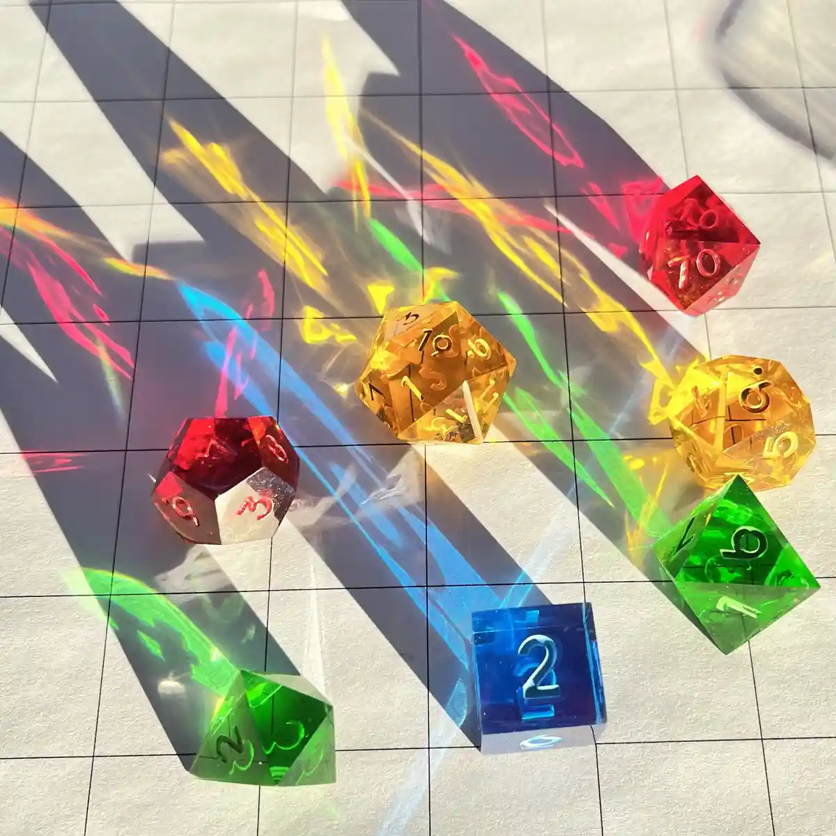 Several colorful, translucent polyhedral dice are scattered on a gridded surface, illuminated by vibrant, rainbow-colored…