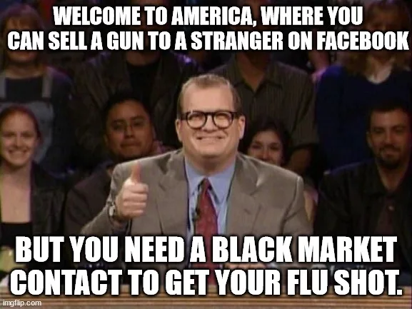 A man in a suit and glasses gives a thumbs-up while seated in front of an audience. White bold text overlays the image…