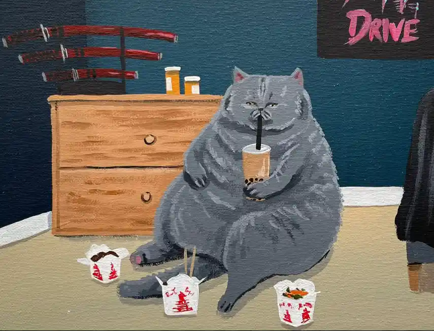A large, gray, chubby cat sits on the floor holding a bubble tea drink with a straw, surrounded by several open Chinese…
