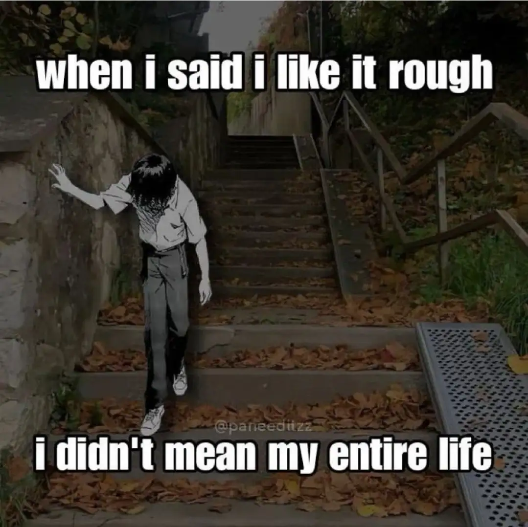 A person with black hair, wearing a white shirt and dark pants, is shown struggling to climb a long, steep outdoor staircase…