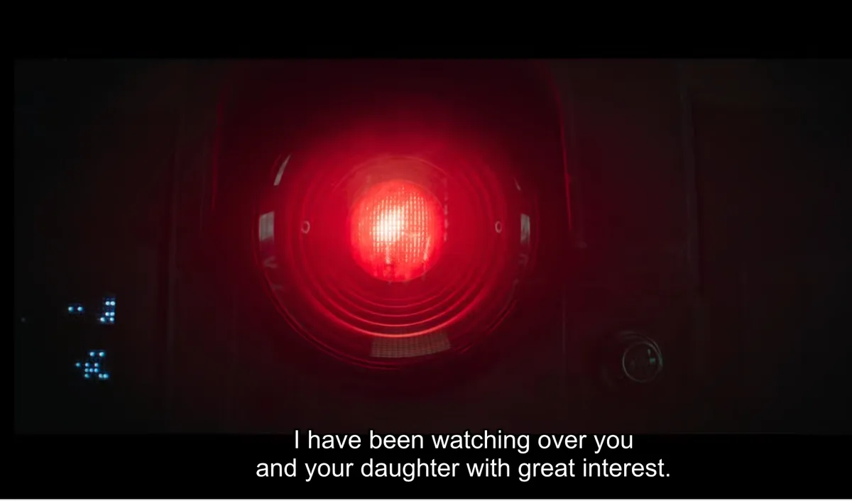 A close-up shot of a glowing red light, likely from a security camera or surveillance system, set against a dark background…
