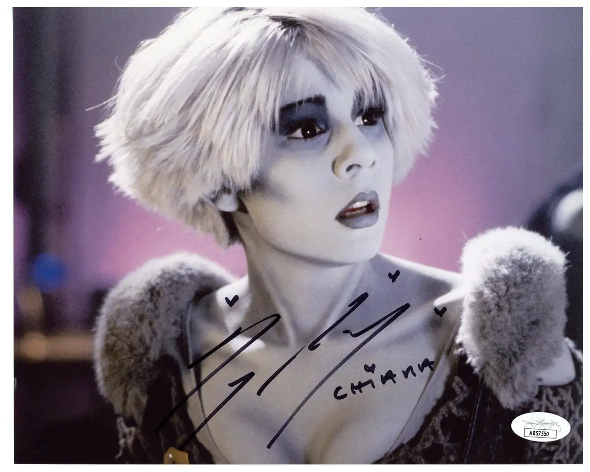 A signed photograph of the character Chiana from the science fiction series Farscape, featuring her with short white hair…