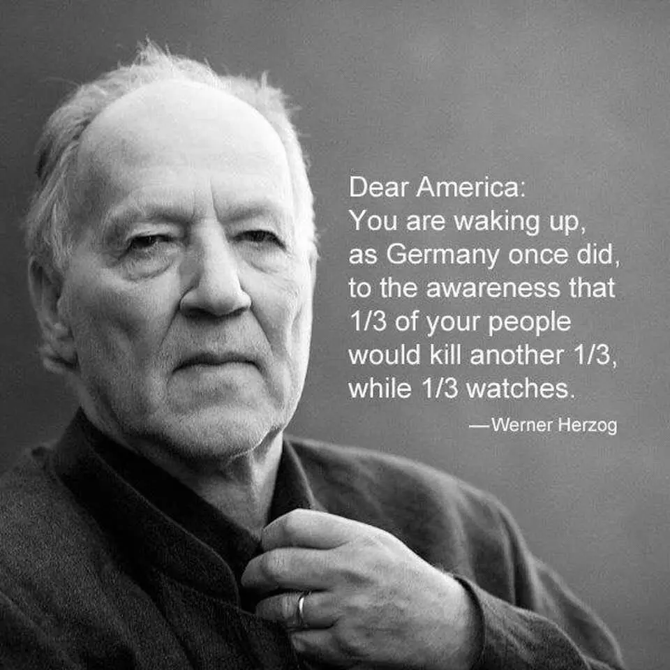 A black-and-white portrait of Werner Herzog, an older man with a serious expression, adjusting his collar. Overlaid text…