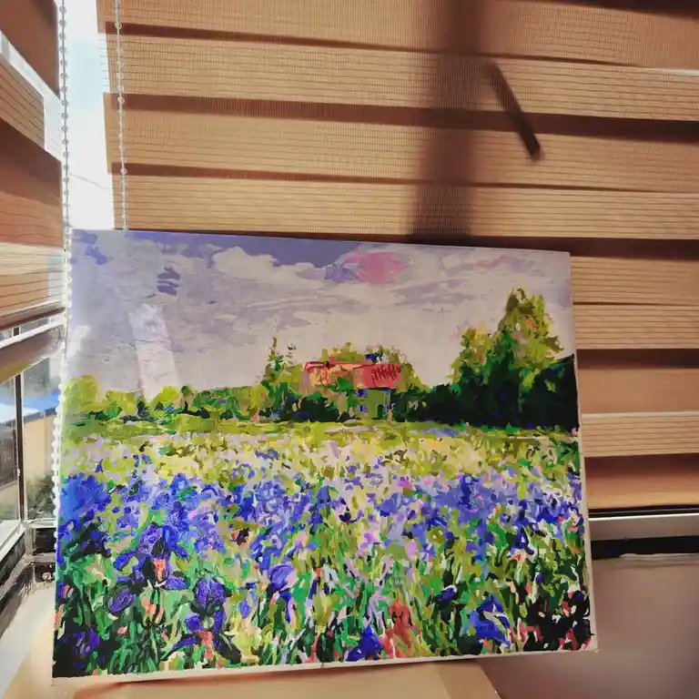A vibrant, impressionistic painting of a field of blue and purple flowers with green foliage and a distant house under a…