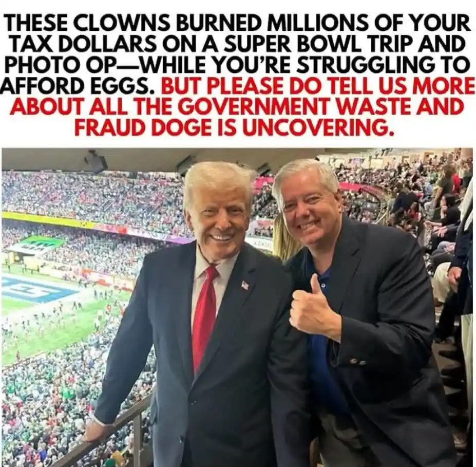 Two men, one with white hair in a dark suit and red tie, the other with gray hair giving a thumbs-up, pose for a photo at a…