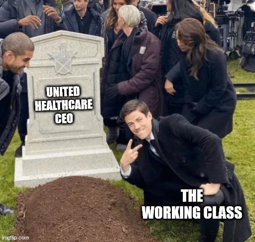 A man in a suit is kneeling beside a freshly dug grave, smiling and making a peace sign, while a tombstone behind him reads…