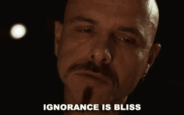 The image displays a split-screen of three identical frames showing a bald man with a mustache and goatee, looking down with…
