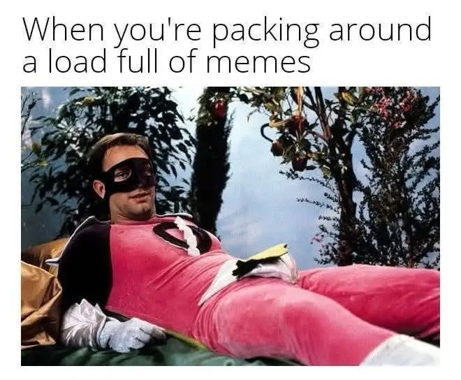 A man in a pink superhero costume with a black mask lies relaxed on a couch, holding a book. The text overlay reads 'When…