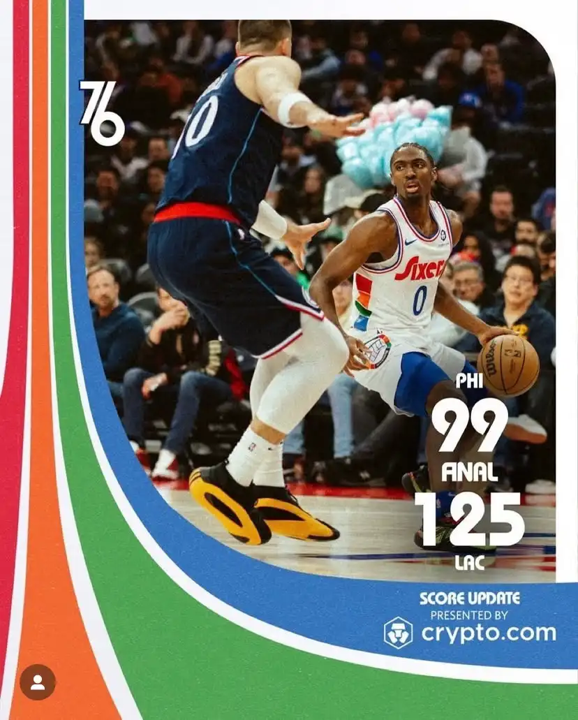 A basketball game photo shows a Philadelphia 76ers player in a white jersey with the number 0 dribbling while being defended…