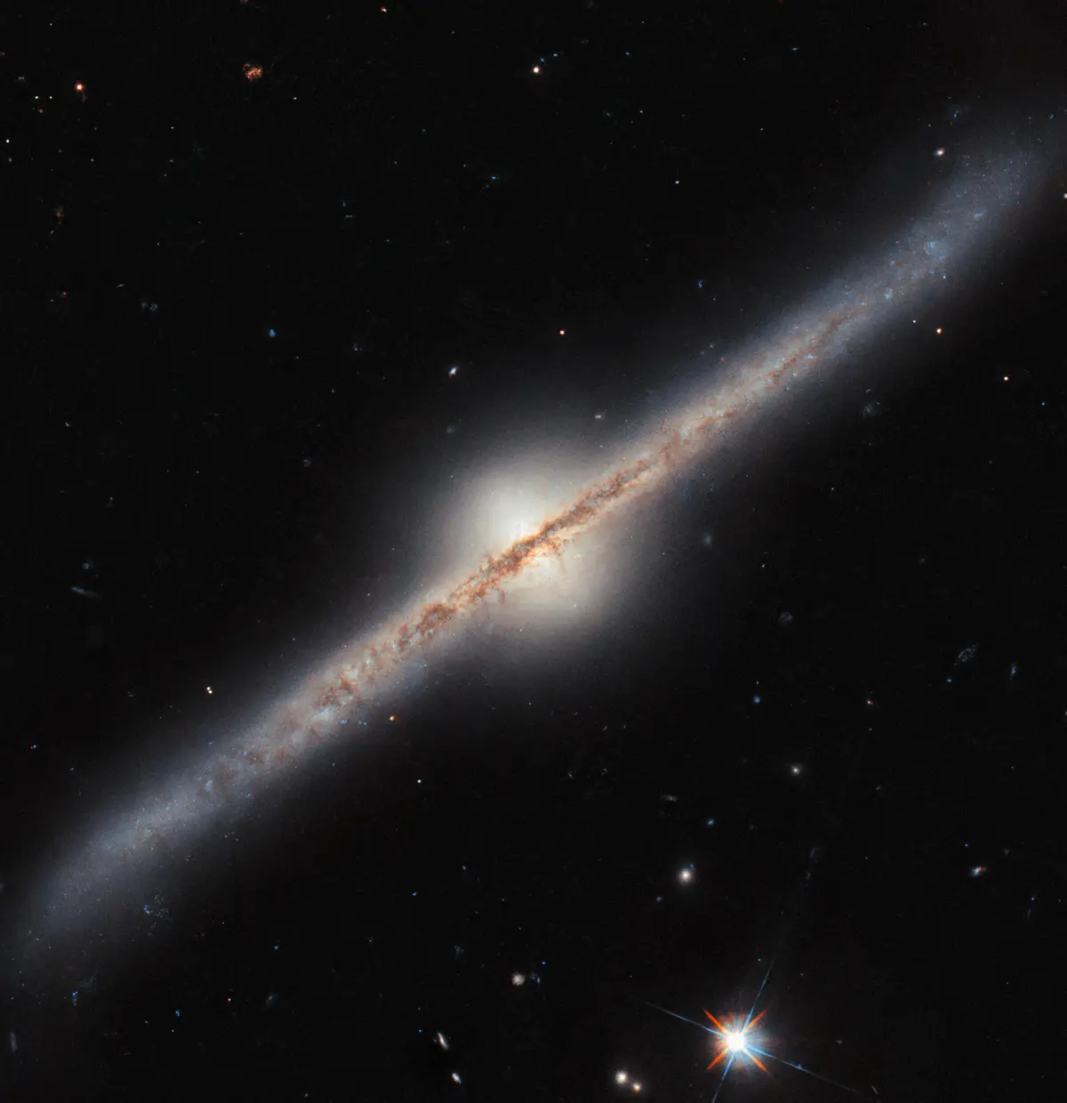 A diagonal view of a spiral galaxy against a starry black background, with overlaid text reading 'i'm not a fan of the new…