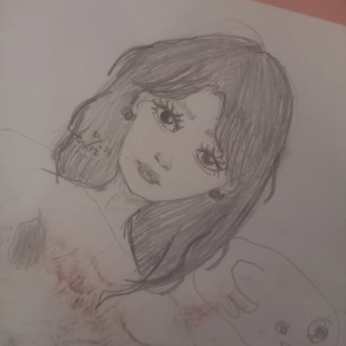A pencil sketch of a young woman with long hair and large eyes, drawn on paper with a date '22-12-24' written in the hair…