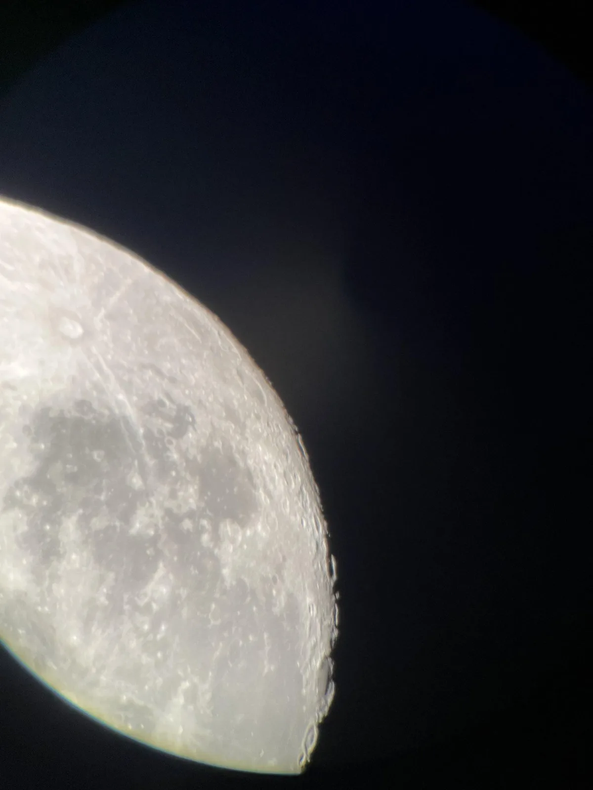 A close-up photograph of the moon's surface against a dark sky, showing craters and textured terrain. The overlaid text…