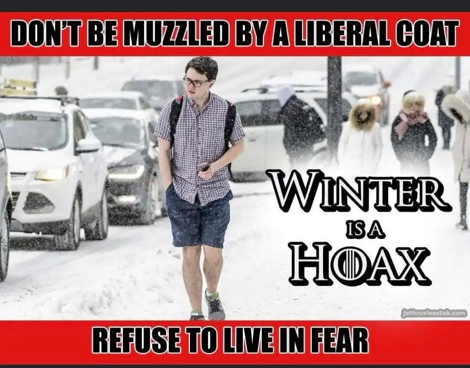 A man wearing shorts and a short-sleeved shirt walks through a snowy street with cars and other people in winter coats…