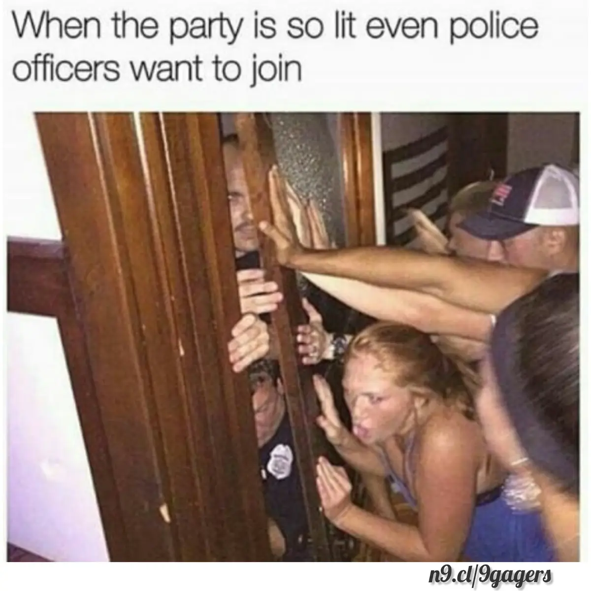 A group of partygoers are pressing their hands and bodies against a wooden door from the inside, trying to get in. Two…