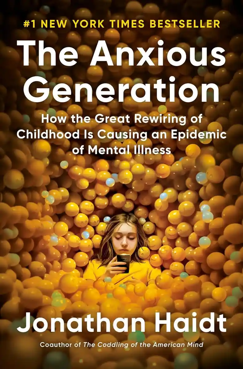 The image is the cover of Jonathan Haidt's book 'The Anxious Generation,' featuring a young girl with eyes closed, holding a…