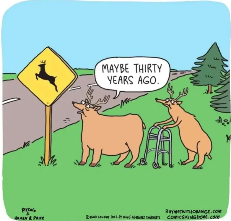 Two cartoon deer stand beside a yellow road sign with a leaping deer silhouette. One deer, appearing elderly and using a…