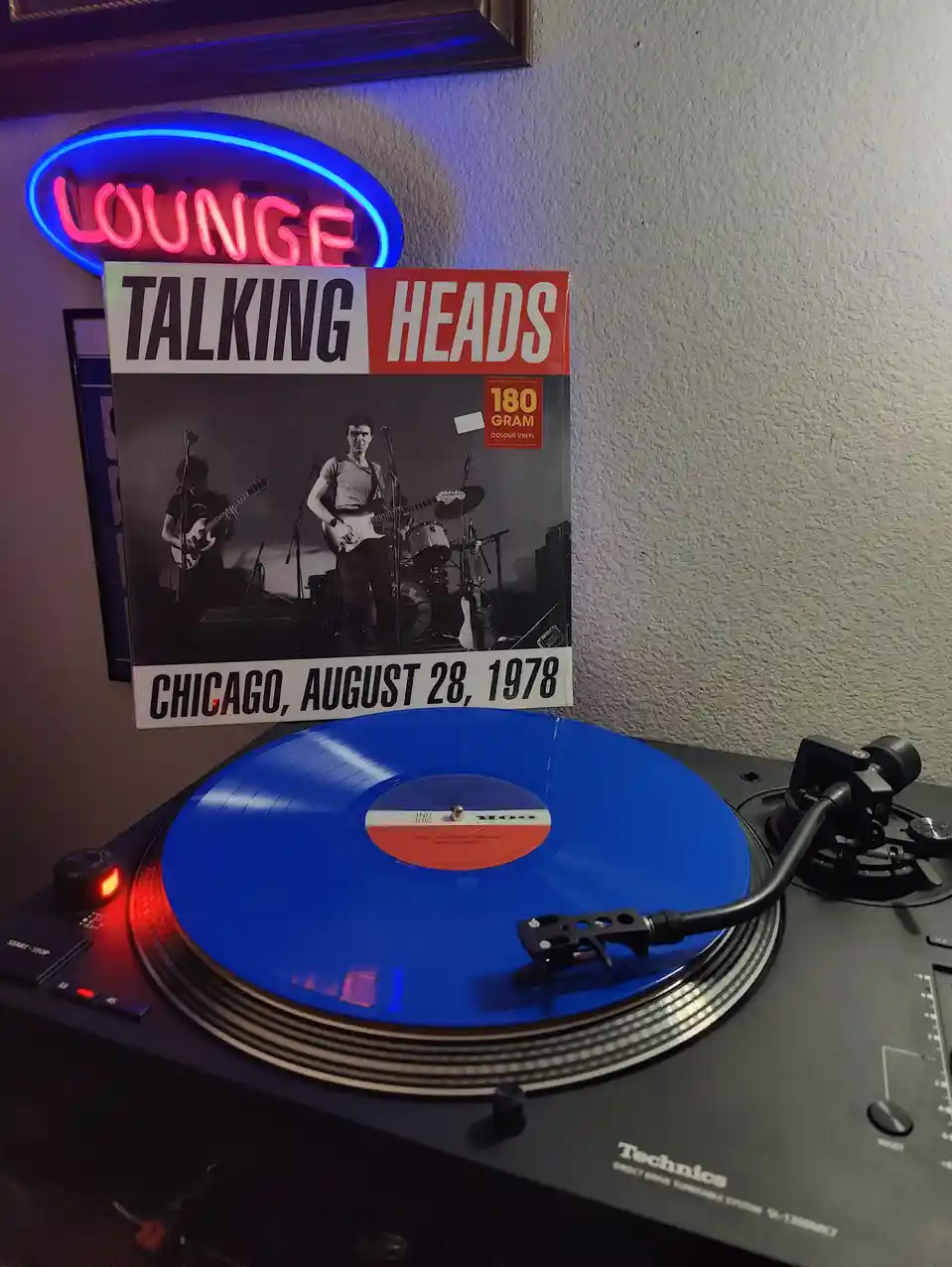 A blue vinyl record spins on a Technics turntable, with its album cover for Talking Heads' 'Chicago, August 28, 1978'…