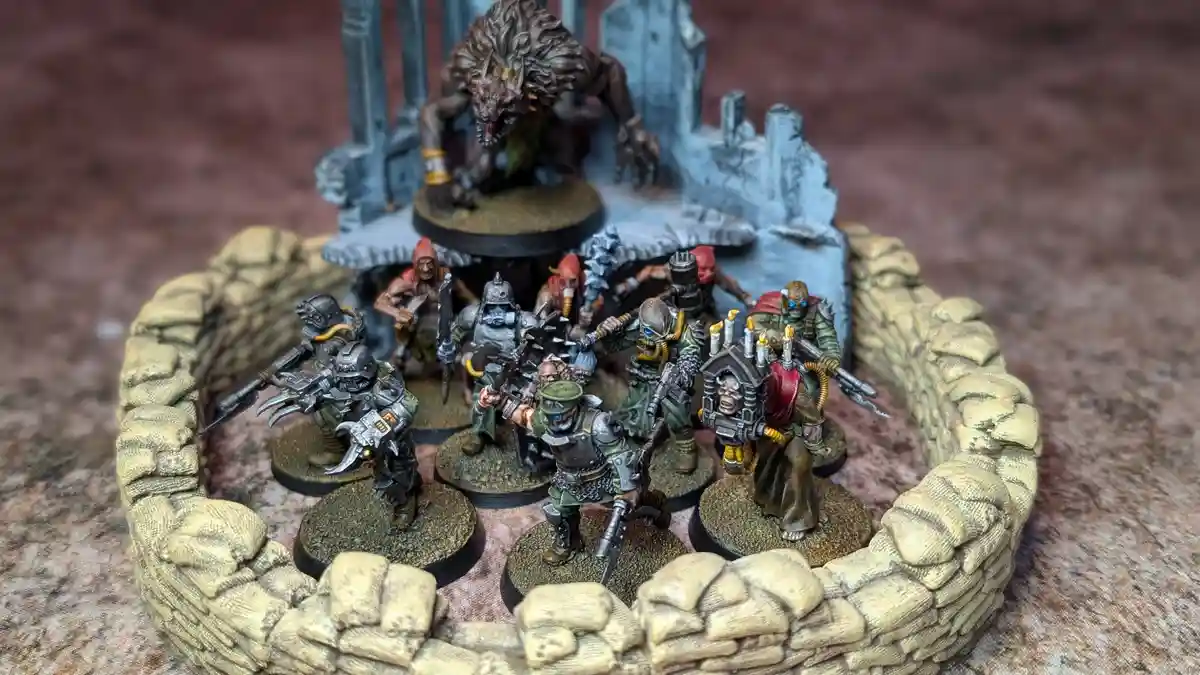 A photo of a miniature wargaming scene featuring a group of painted fantasy soldiers in a semi-circle formation behind a…