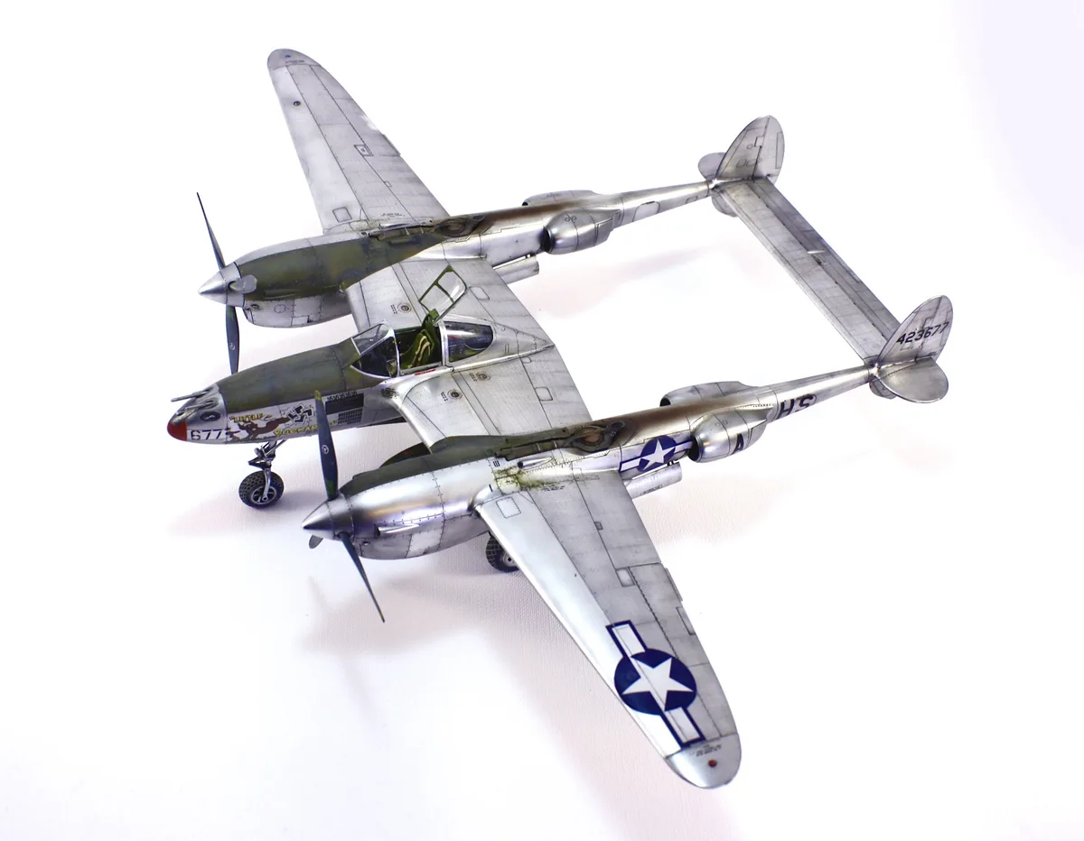 A detailed model of a twin-engine American WWII fighter plane, likely a P-38 Lightning, is shown against a plain white…