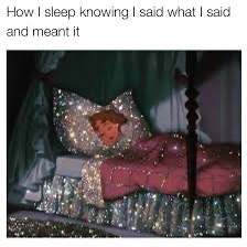 A person is lying in bed under a sparkly, glitter-covered comforter and pillowcase, appearing to sleep peacefully. The…