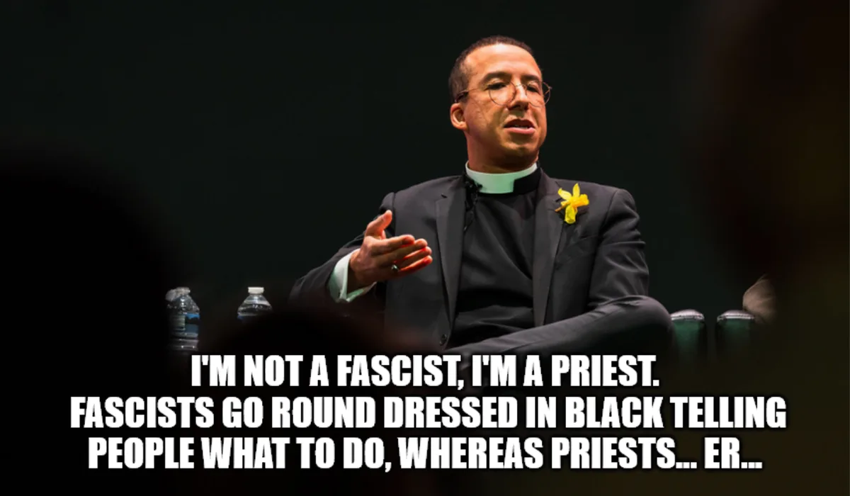 A man in clerical collar and suit gestures while speaking, with overlaid text reading 'I'M NOT A FASCIST, I'M A PRIEST…