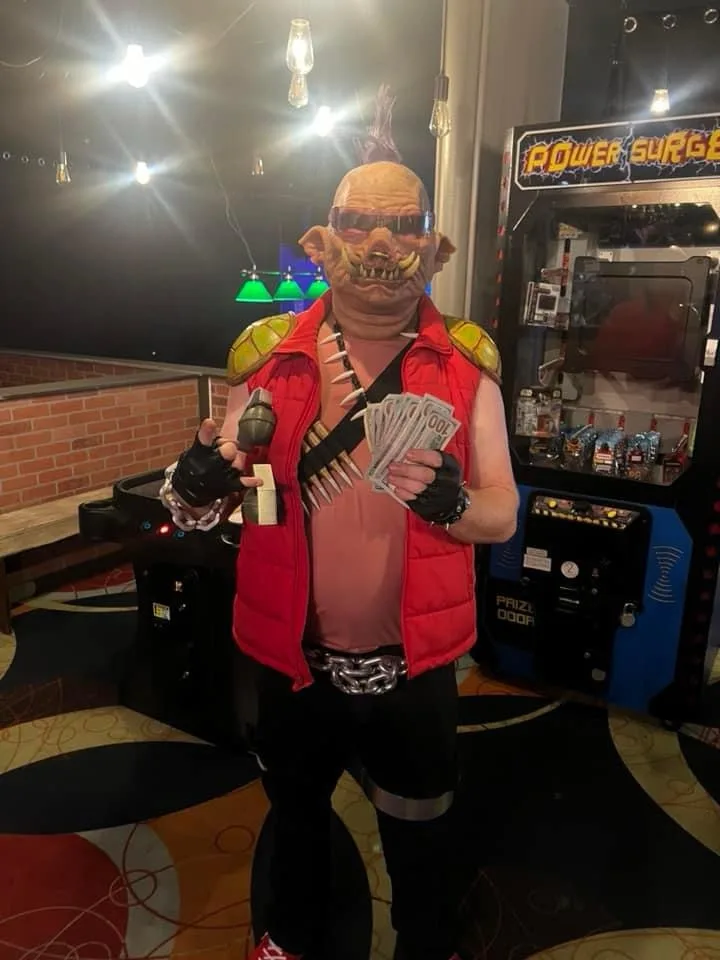 A person in a full-body costume resembling the video game character 'Mega Man' (specifically, the villainous 'Dr. Wily' or…