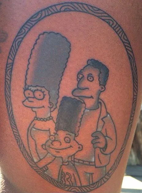 A tattoo on human skin depicts the Simpson family in a black-and-gray oval frame, showing Marge, Homer, and Bart Simpson…