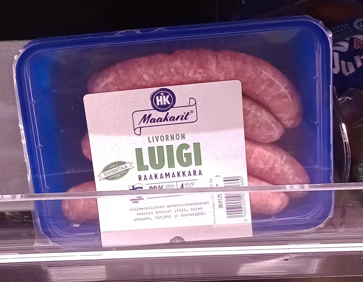 A package of raw sausages in a blue plastic container, labeled 'LUIGI' in large green letters, sits on a supermarket shelf…