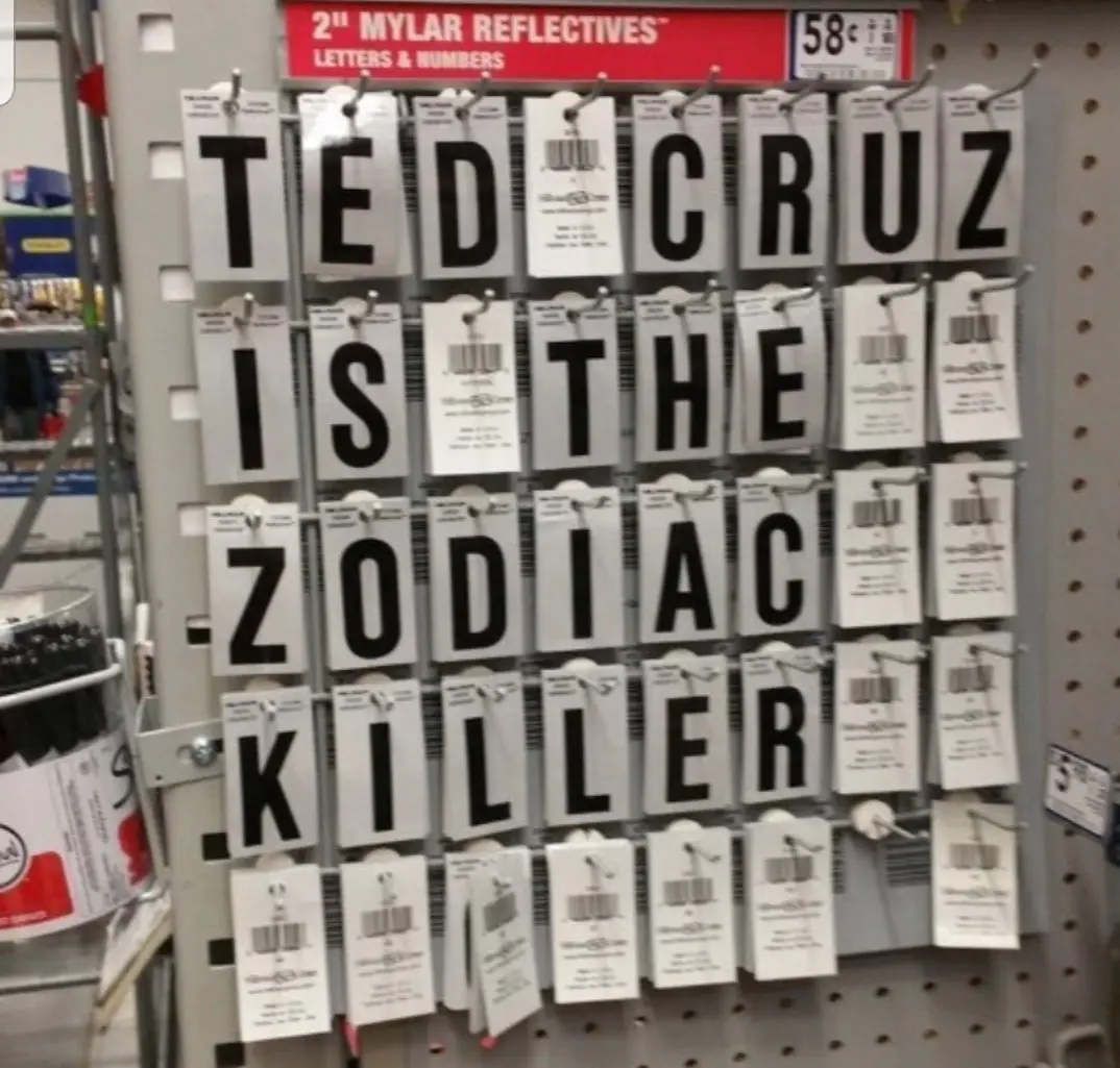 A store shelf displays large, reflective, 2-inch mylar letters and numbers for sale, arranged to spell out the phrase 'TED…