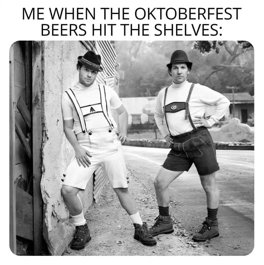 A black-and-white photo shows two men in traditional Oktoberfest attire, including suspenders, shorts, and bowler hats…