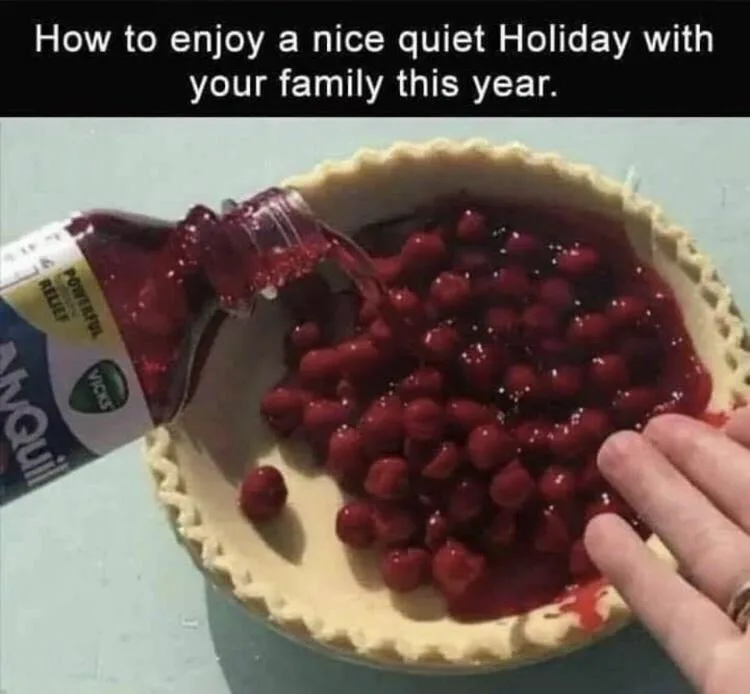 A hand holds a pie crust while a bottle of Advil liquid is poured into it, filling it with red cherry pie filling. The…