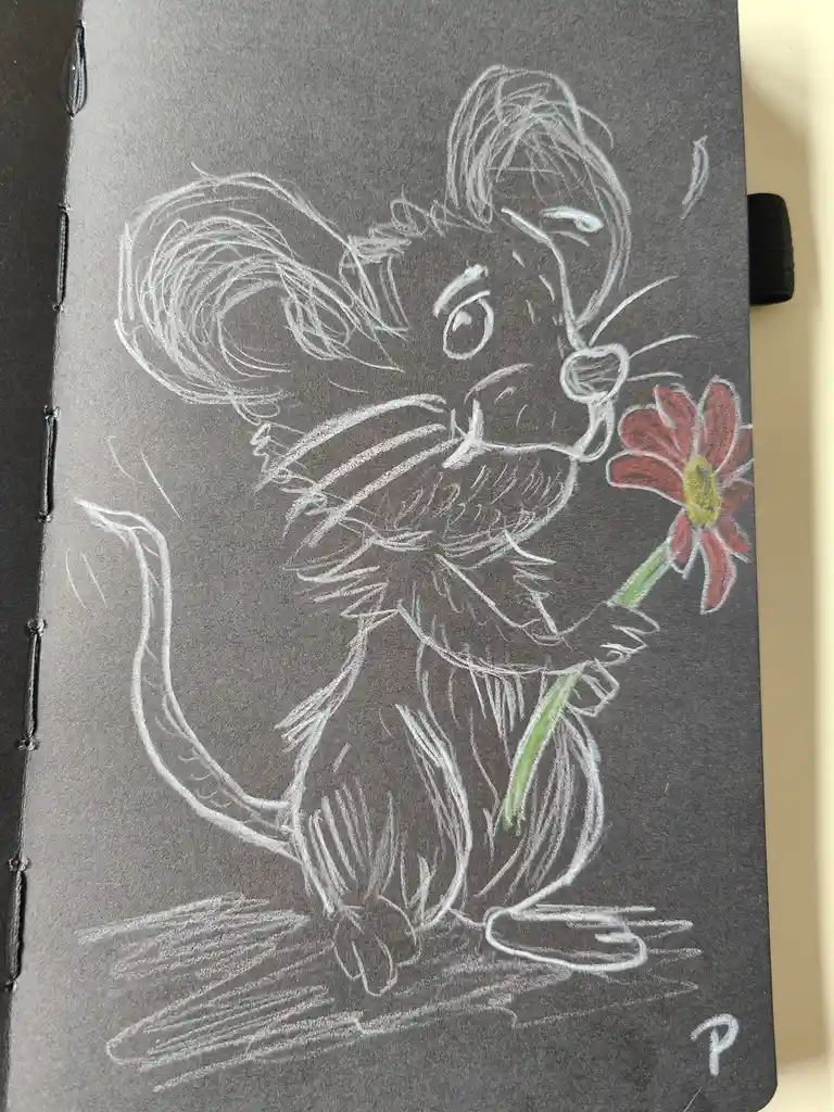 A chalk drawing on dark grey paper shows a cartoon mouse with large ears and a long tail, holding a red flower with a yellow…