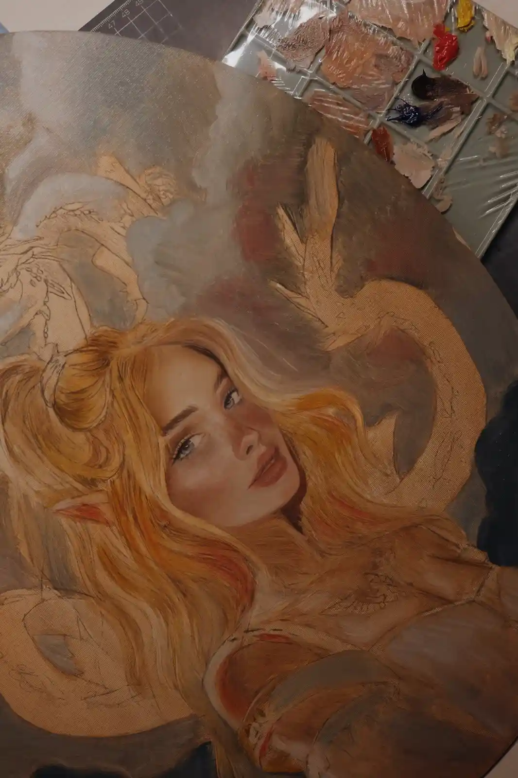 A close-up of an unfinished oil painting on canvas shows a female elf-like character with long blonde hair and pointed ears…
