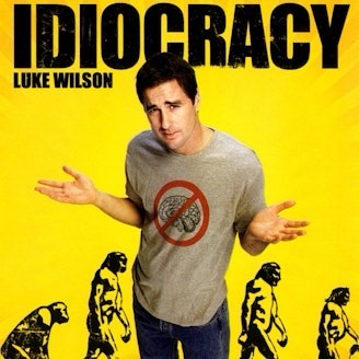 A promotional poster for the movie 'Idiocracy' featuring actor Luke Wilson standing in the center with his arms outstretched…